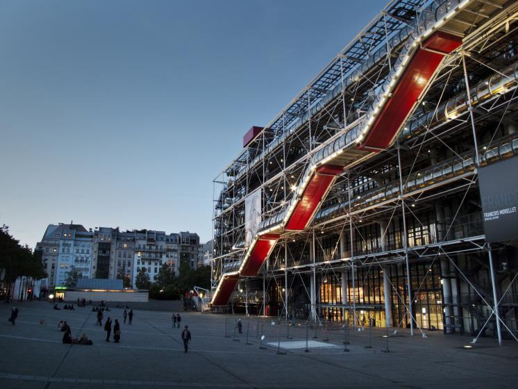 The Centre Georges Pompidou (known locally as Beaubourg) with the Place Georges Pompidou in front of it, in the Marais area of Paris, at twilight.